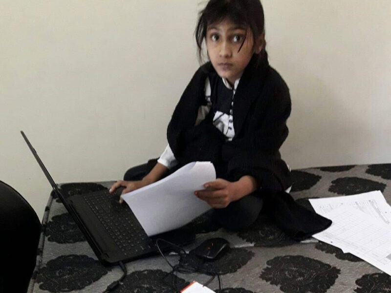 Young girl working on laptop