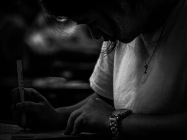 Close-up of young woman writing