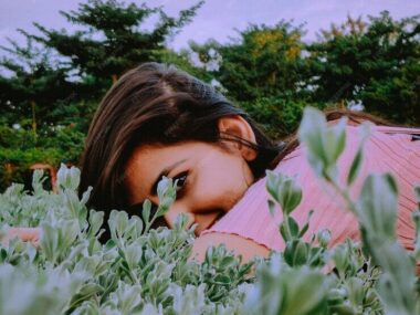 Portrait of woman lying down on plants