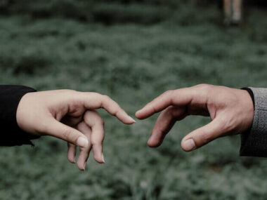 Romantic prewedding with the hands of lovers who meet each other accompanied by a cool natural