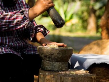 A woman cutting lemon grass on a wooden board in Chiang Mai Thailand