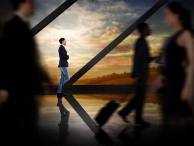 Businessman standing against room with large window looking on landscape