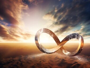 An infinity sign in the desert with the sun behind it