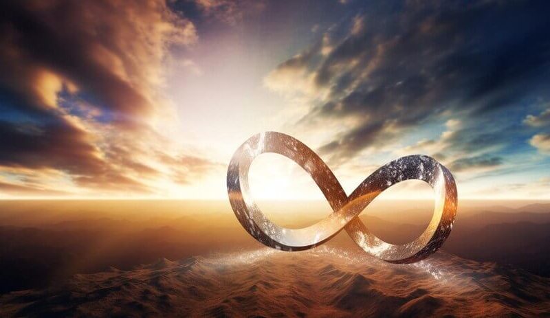 An infinity sign in the desert with the sun behind it