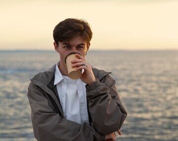 Medium shot contemplative man at the seaside