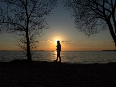 Sad and contemplative person near lake