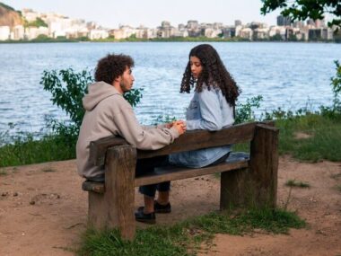 Sad couple sitting together outdoors