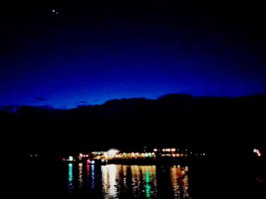 Scenic view of lake against sky at night