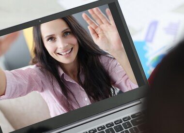 Woman talking with an online communication officer with laptop