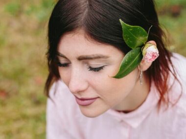 Charming woman with bloom and leaves in hair