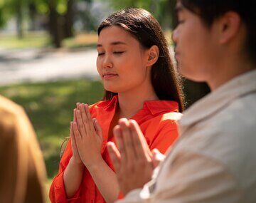 Medium shot young people praying outdoors