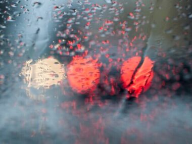 Photographed road defocusing. Close-up, visible red car lights