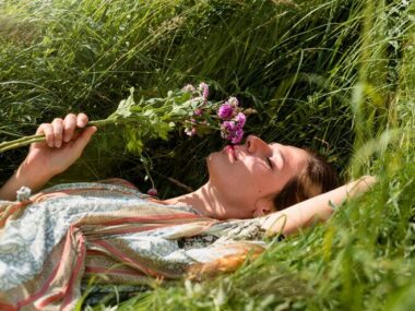 Woman laying on grass side view