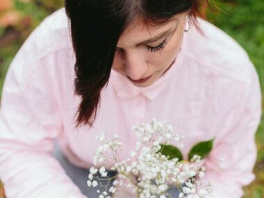 Charming woman with bunch of plant with white blooms