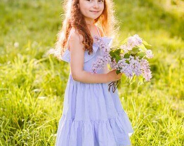 Innocent girl holding flower bunch