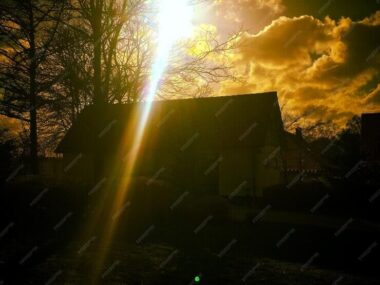 Silhouette house during sunset