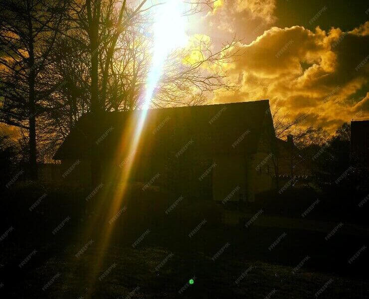 Silhouette house during sunset