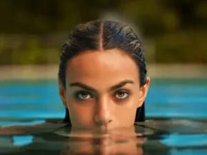 Photo of a Woman Emerging from the Water in a Swimming Pool