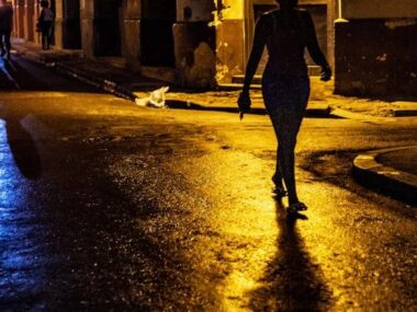 Silhouette Photo of Woman Walking on Road during