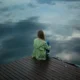 Woman Sitting on Wooden Planks