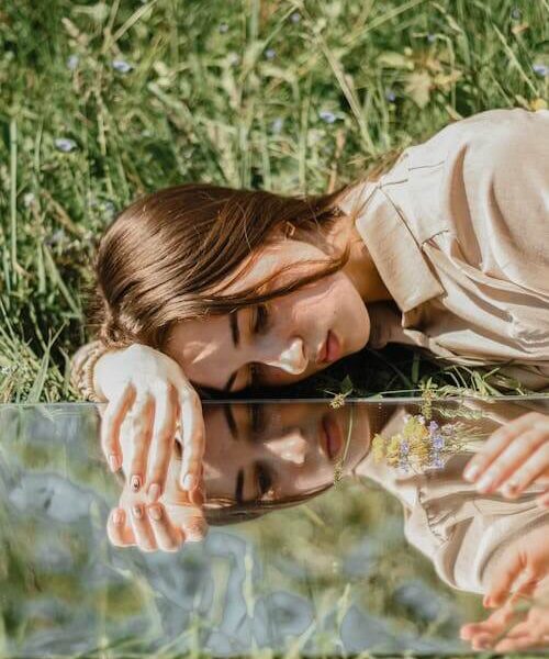 Photo of Woman Laying on the Grass