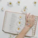 A hand on book with praying message