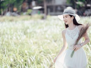 Positive ethnic woman enjoying nature in rural environment