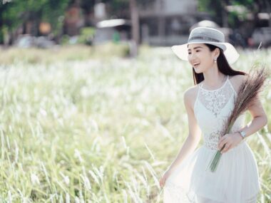 Positive ethnic woman enjoying nature in rural environment