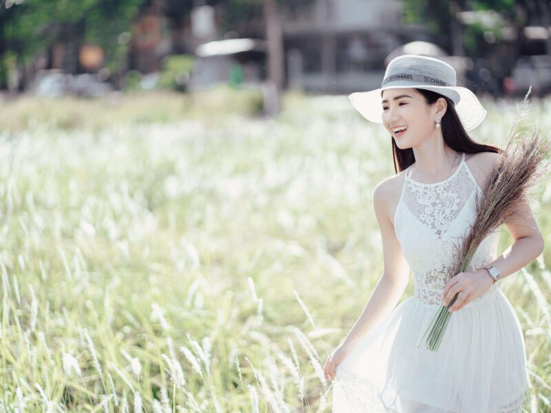 Positive ethnic woman enjoying nature in rural environment
