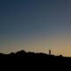 Silhouette of a Person Walking on a Hill in evening